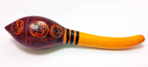 A gourd shaker with a brown end with fire-burned designs and a yellow stem