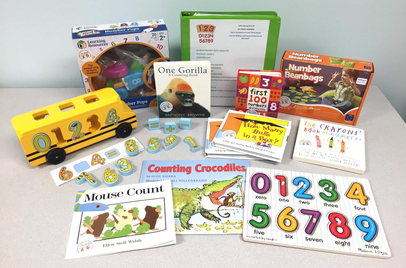 Contents of the All About Numbers Early Literacy Kit including number beanbags, books, and puzzles